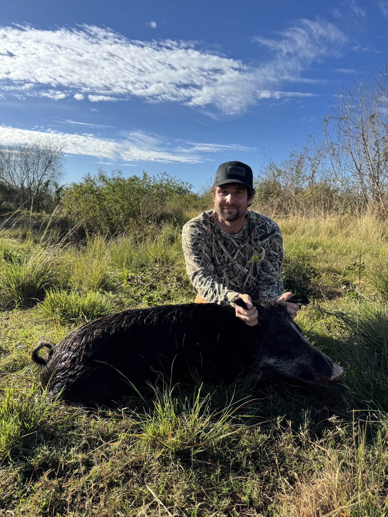 Hunter with black wild hog Florida