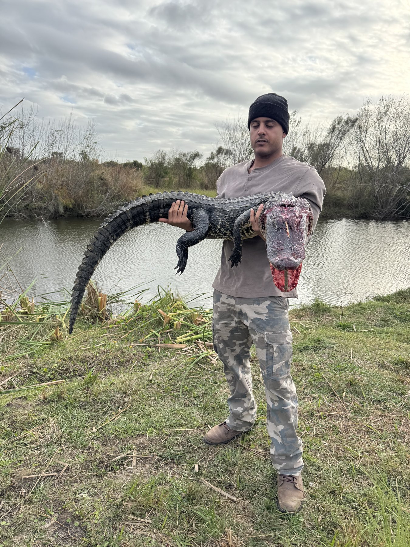 Hunter holding alligator on Peace River Florida